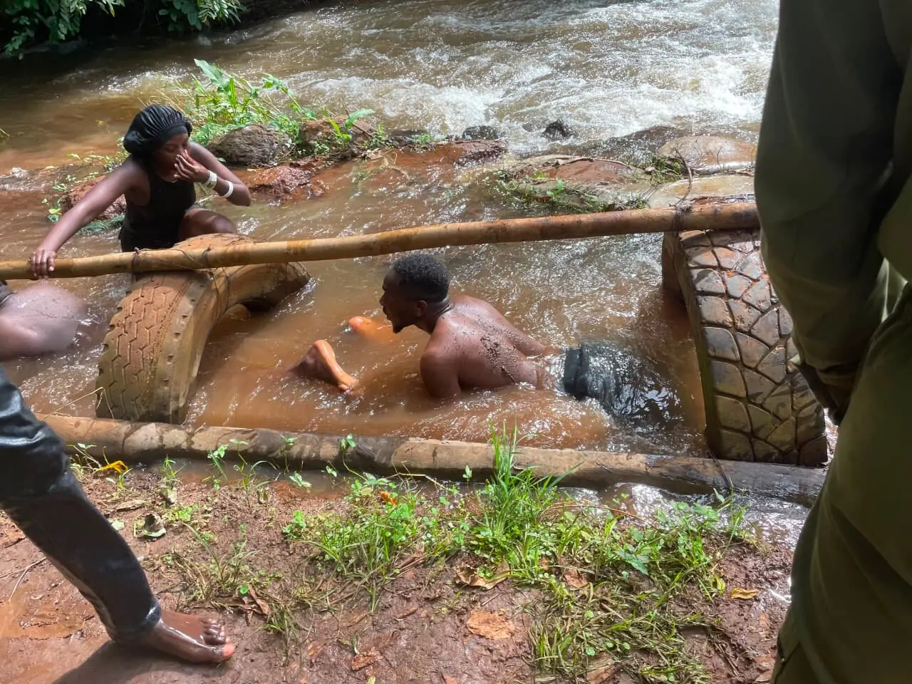 Trip members working together through a river tire obstacle course
